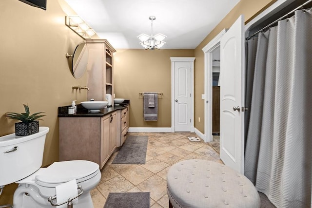 bathroom featuring tile patterned floors, a chandelier, toilet, vanity, and a shower with shower curtain