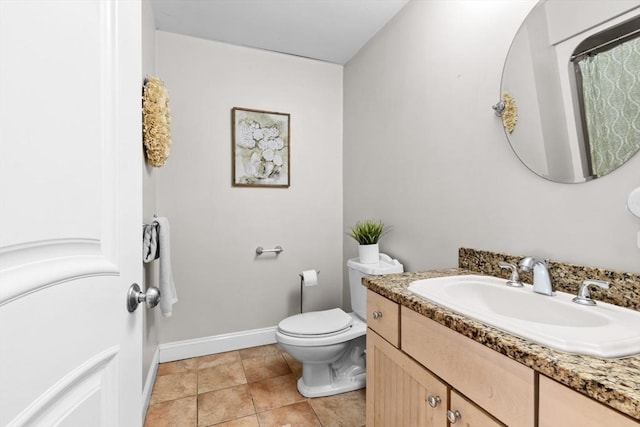 bathroom with tile patterned floors, vanity, and toilet