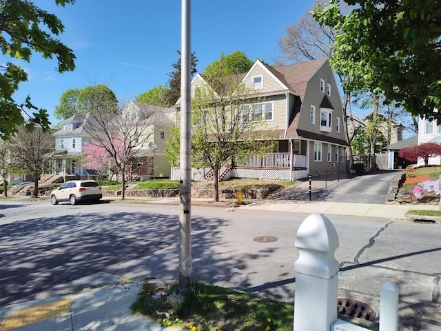view of road featuring a residential view, sidewalks, and curbs