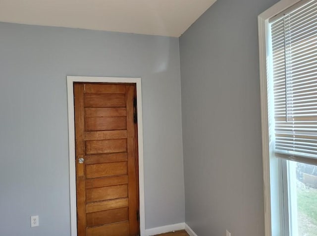 unfurnished room featuring baseboards