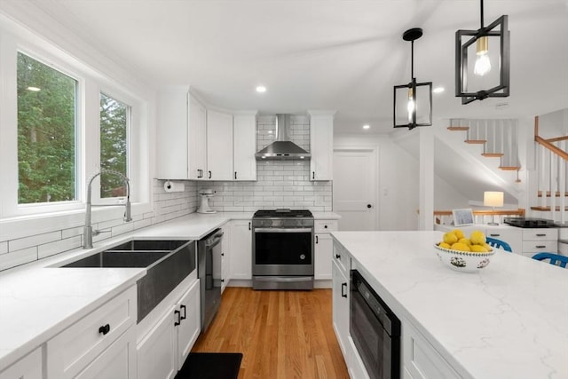 21 Pembrook Rd, North Andover, MA 01845 - kitchen with appliances with stainless steel finishes, wall chimney range hood, decorative backsplash, white cabinets, and light stone countertops