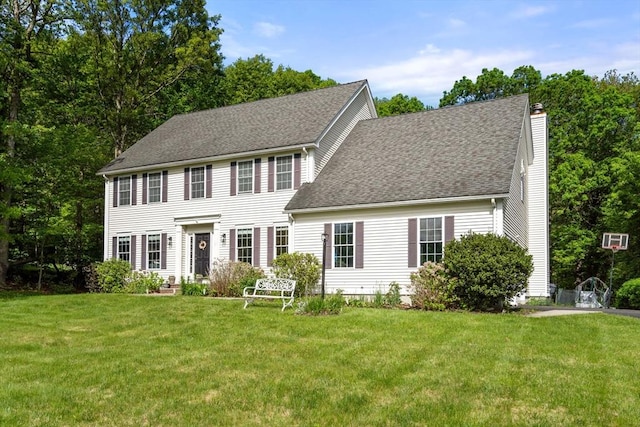 10 Primrose Ln, Westborough, MA 01581 - colonial house with a front lawn, a chimney, and roof with shingles