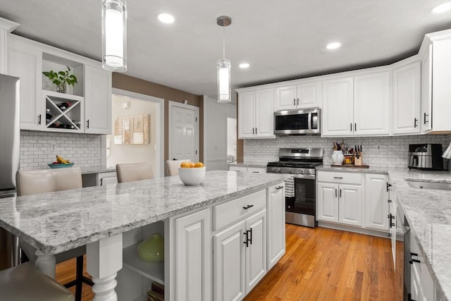 10 Primrose Ln, Westborough, MA 01581 - kitchen featuring stainless steel appliances, open shelves, decorative backsplash, white cabinetry, and recessed lighting
