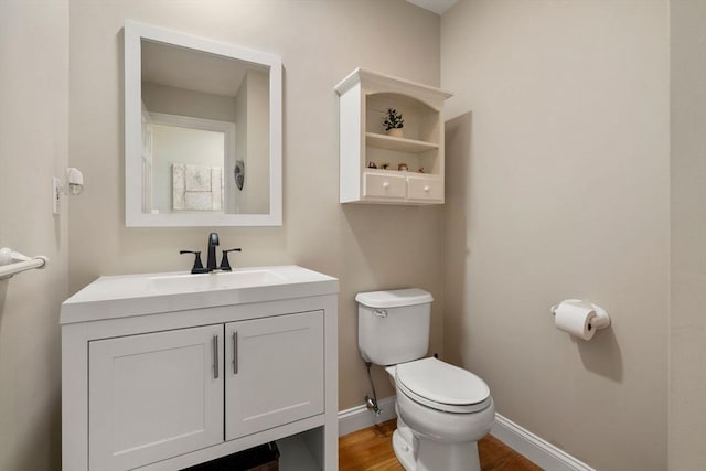 10 Primrose Ln, Westborough, MA 01581 - bathroom featuring toilet, vanity, baseboards, and wood finished floors