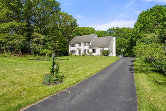 10 Primrose Ln, Westborough, MA 01581 - colonial home featuring a front yard and a chimney