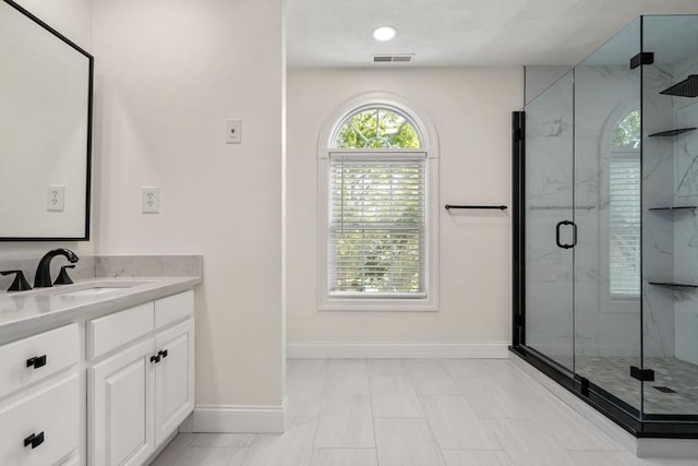 10 Primrose Ln, Westborough, MA 01581 - bathroom featuring baseboards, vanity, and a marble finish shower