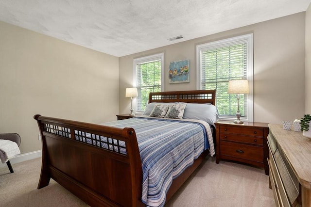 10 Primrose Ln, Westborough, MA 01581 - bedroom with light colored carpet, multiple windows, and baseboards