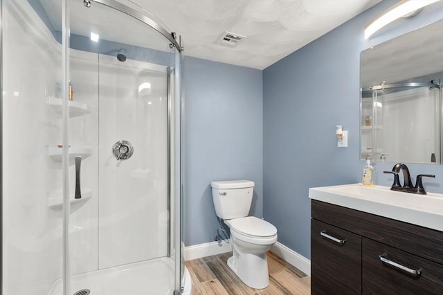 10 Primrose Ln, Westborough, MA 01581 - bathroom featuring a shower stall, toilet, wood finished floors, vanity, and baseboards