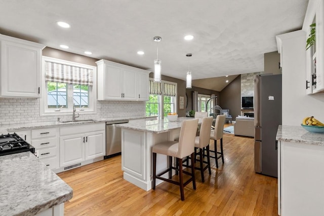 10 Primrose Ln, Westborough, MA 01581 - kitchen featuring appliances with stainless steel finishes, a sink, open floor plan, a center island, and white cabinetry