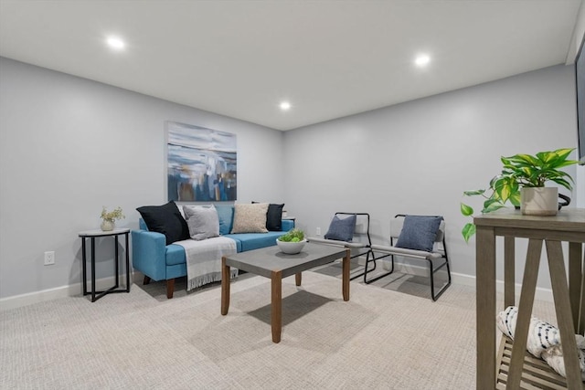 living room featuring recessed lighting, baseboards, and light colored carpet