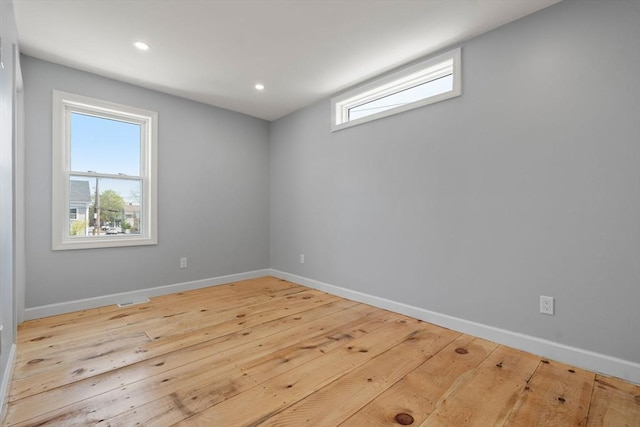 spare room featuring baseboards and a wealth of natural light