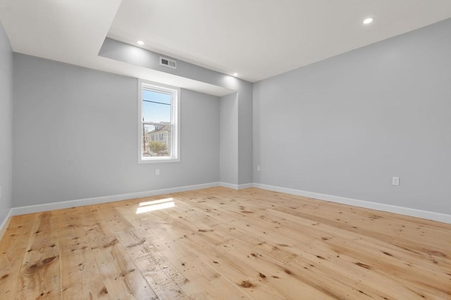 spare room with recessed lighting, baseboards, visible vents, and hardwood / wood-style flooring