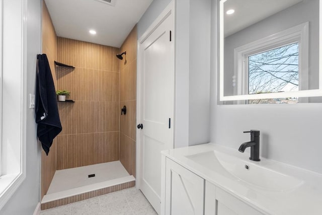 bathroom featuring vanity, recessed lighting, and tiled shower