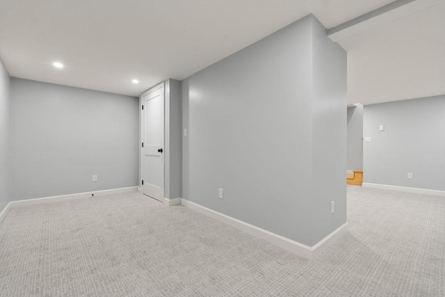 basement with light colored carpet, recessed lighting, and baseboards