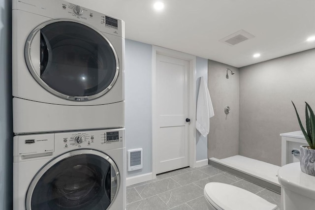 full bathroom with a walk in shower, stacked washer / drying machine, toilet, and visible vents