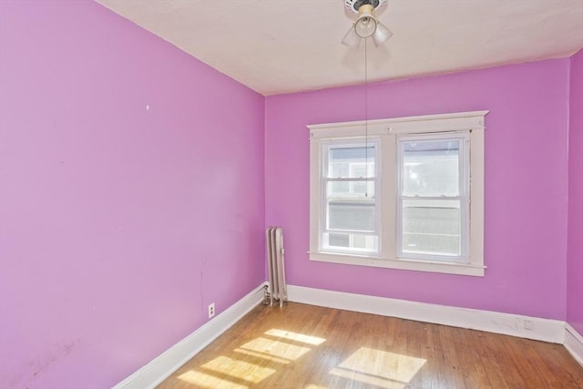 16 Worthen St, West Springfield, MA 01089 - empty room with wood finished floors, ceiling fan, and radiator