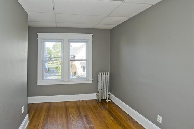 16 Worthen St, West Springfield, MA 01089 - unfurnished room featuring radiator heating unit, a paneled ceiling, and wood finished floors