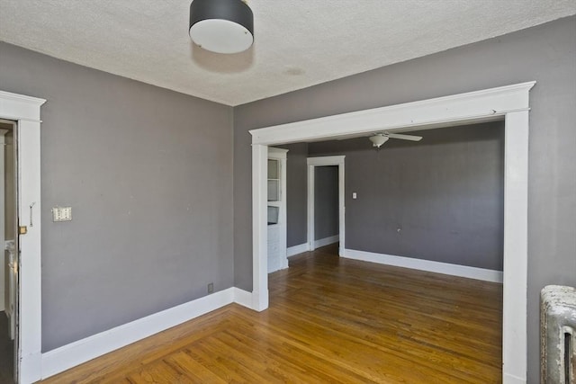 16 Worthen St, West Springfield, MA 01089 - spare room featuring radiator, wood finished floors, a ceiling fan, and a textured ceiling