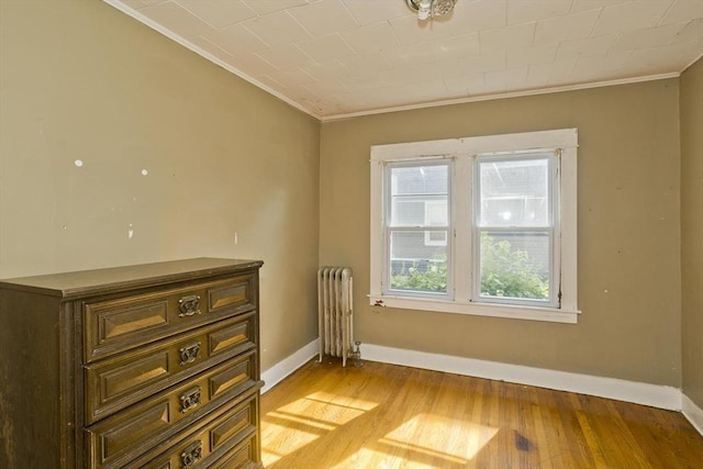 16 Worthen St, West Springfield, MA 01089 - spare room with radiator heating unit, ornamental molding, and light wood-type flooring