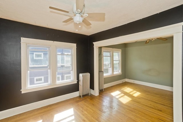 16 Worthen St, West Springfield, MA 01089 - empty room featuring radiator, wood finished floors, and ceiling fan