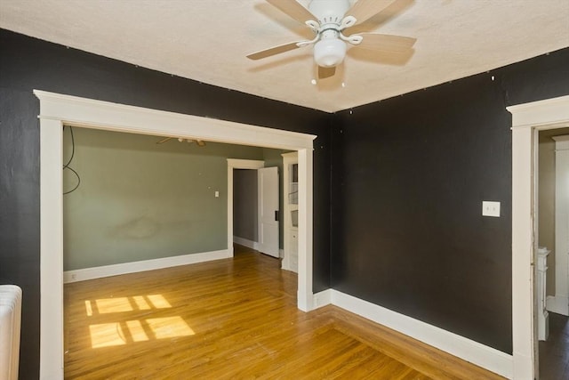 16 Worthen St, West Springfield, MA 01089 - spare room with wood finished floors, a ceiling fan, and radiator heating unit