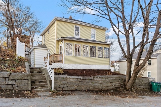 front facade with a sunroom