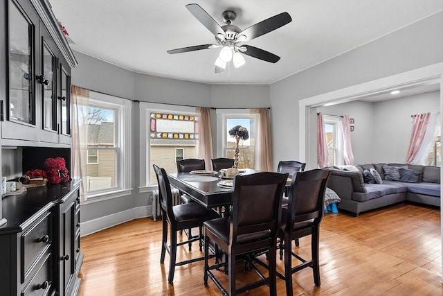 dining room with hardwood / wood-style floors, ceiling fan, and a healthy amount of sunlight