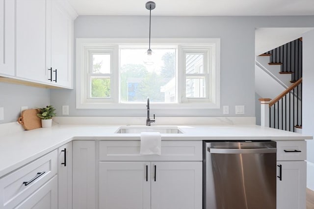 18 Beaumont Rd, Worcester, MA 01604 - kitchen with stainless steel dishwasher, a sink, white cabinetry, pendant lighting, and light countertops