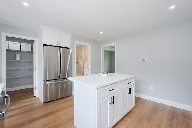 18 Beaumont Rd, Worcester, MA 01604 - kitchen with freestanding refrigerator, light wood finished floors, white cabinetry, baseboards, and recessed lighting