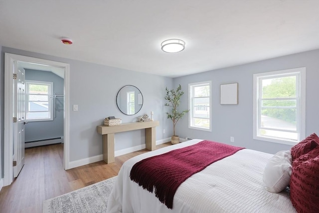 18 Beaumont Rd, Worcester, MA 01604 - bedroom with baseboard heating, multiple windows, light wood-type flooring, and baseboards