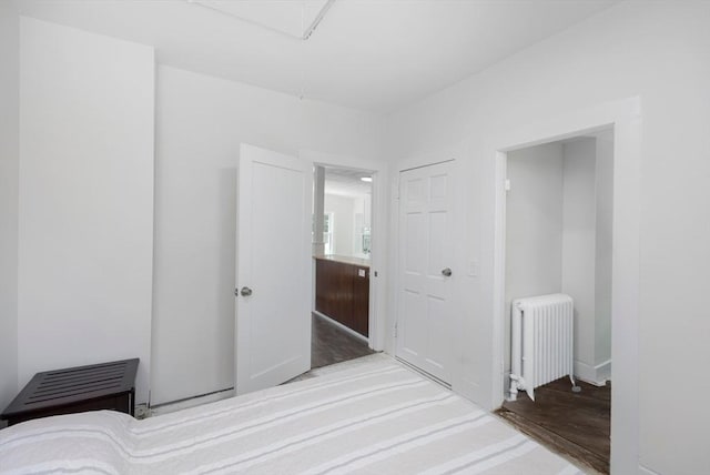 147 Fairmount Ave, Lynn, MA 01905 - unfurnished bedroom featuring radiator, wood finished floors, a closet, and attic access