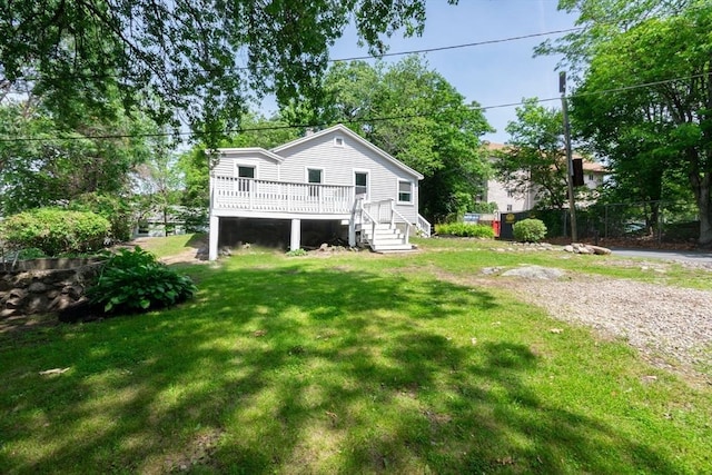147 Fairmount Ave, Lynn, MA 01905 - rear view of house featuring a deck and a lawn
