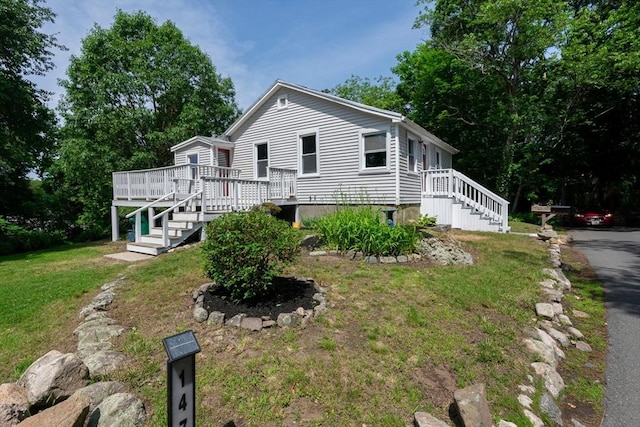 147 Fairmount Ave, Lynn, MA 01905 - view of front of house featuring a front lawn, a deck, and stairway