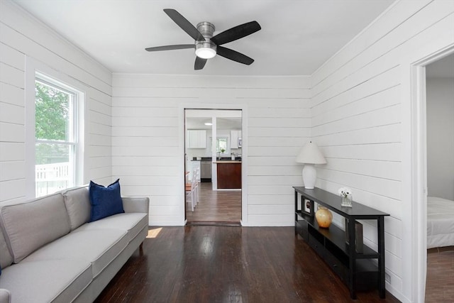 147 Fairmount Ave, Lynn, MA 01905 - living area with wood finished floors, wooden walls, ceiling fan, and crown molding