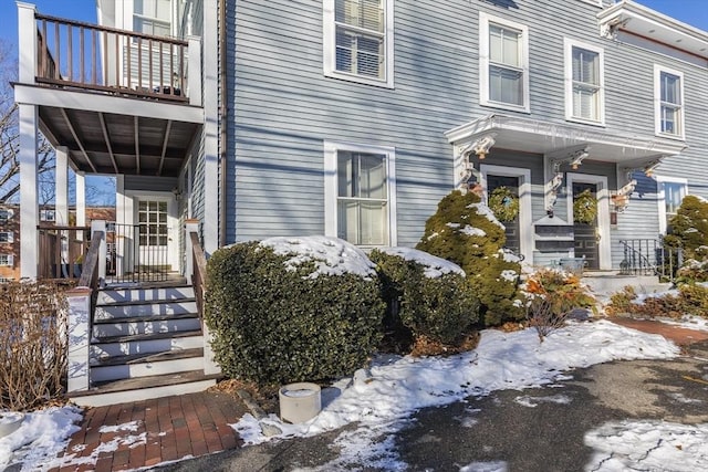 view of snow covered property entrance