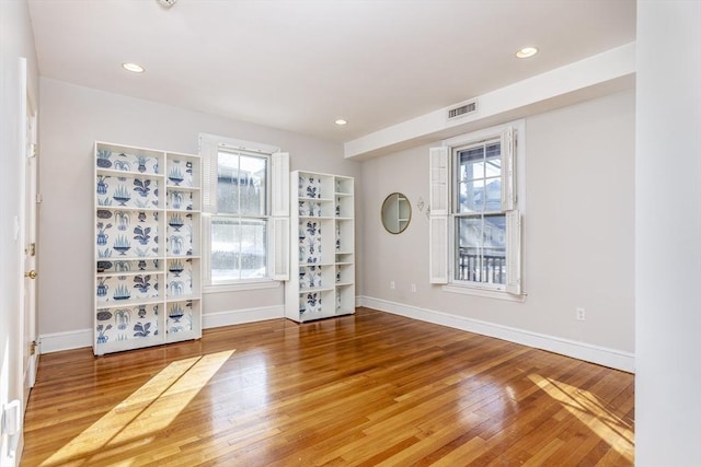 empty room with hardwood / wood-style flooring