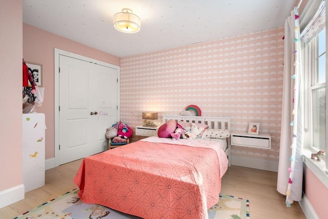 bedroom featuring baseboards and wood finished floors