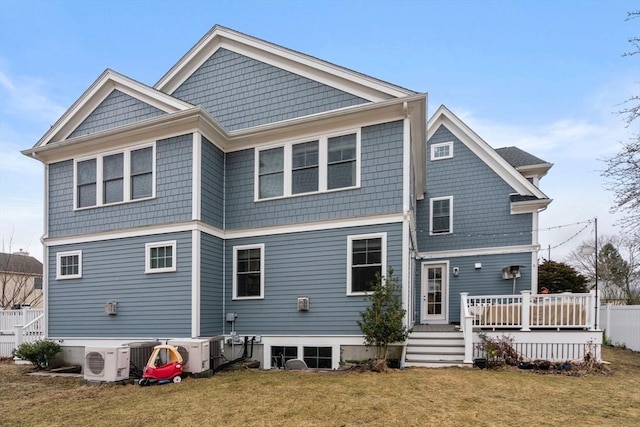 rear view of property with ac unit, a lawn, a deck, and fence