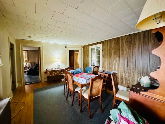 dining room with wood walls