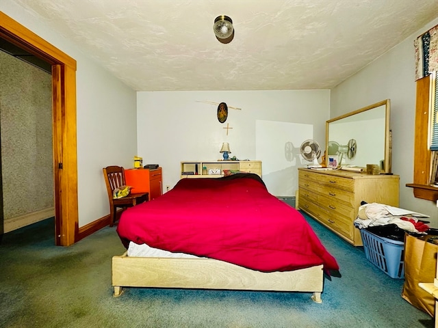 bedroom with a baseboard radiator, dark carpet, and a textured ceiling