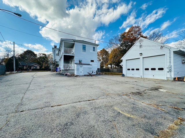 exterior space featuring a garage and a balcony