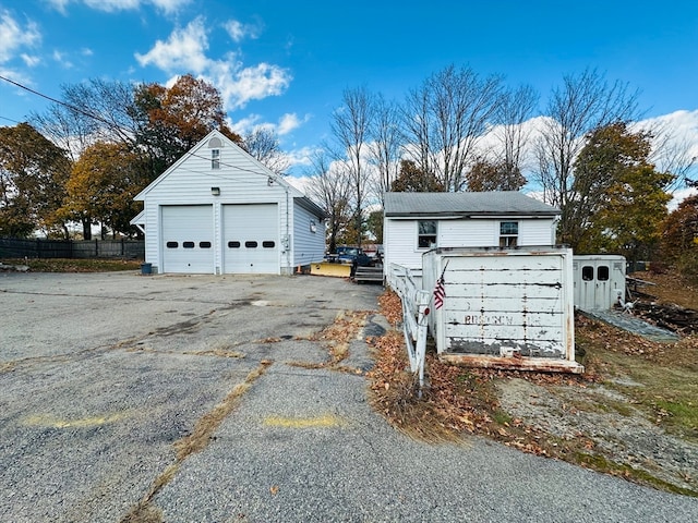 exterior space featuring a garage and an outdoor structure