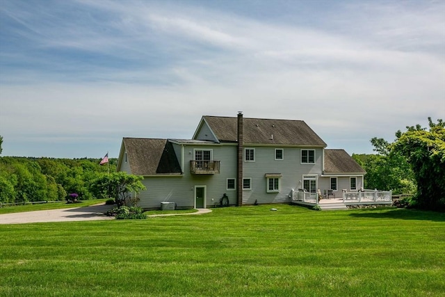 27 Southwick Rd, Sutton, MA 01590 - back of property featuring a lawn, a wooden deck, and central air condition unit