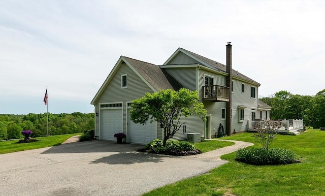 27 Southwick Rd, Sutton, MA 01590 - view of side of home with a balcony, a lawn, a garage, central air condition unit, and a chimney