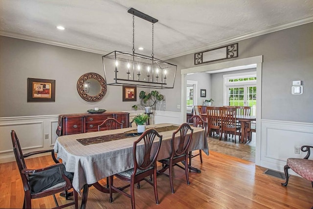 27 Southwick Rd, Sutton, MA 01590 - dining area with crown molding, wainscoting, wood finished floors, a decorative wall, and recessed lighting