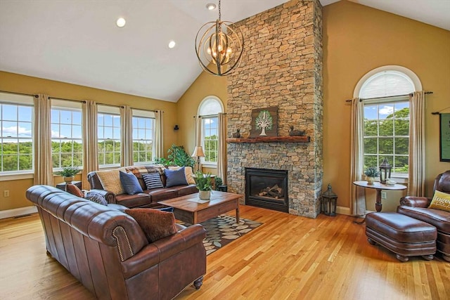 27 Southwick Rd, Sutton, MA 01590 - living area featuring high vaulted ceiling, wood finished floors, baseboards, a chandelier, and a fireplace