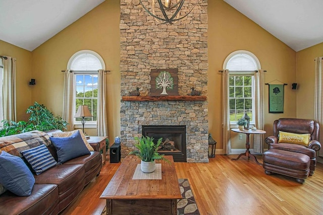 27 Southwick Rd, Sutton, MA 01590 - living room with high vaulted ceiling, plenty of natural light, wood finished floors, a stone fireplace, and baseboards