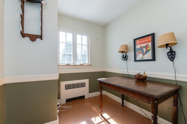 office space featuring baseboards and radiator