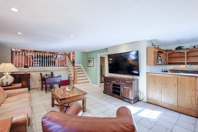 living room featuring stairs, baseboards, wet bar, and recessed lighting