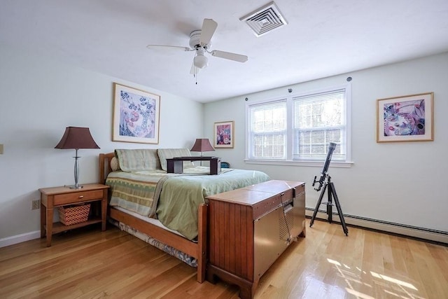 bedroom featuring ceiling fan, a baseboard radiator, visible vents, and light wood-style floors